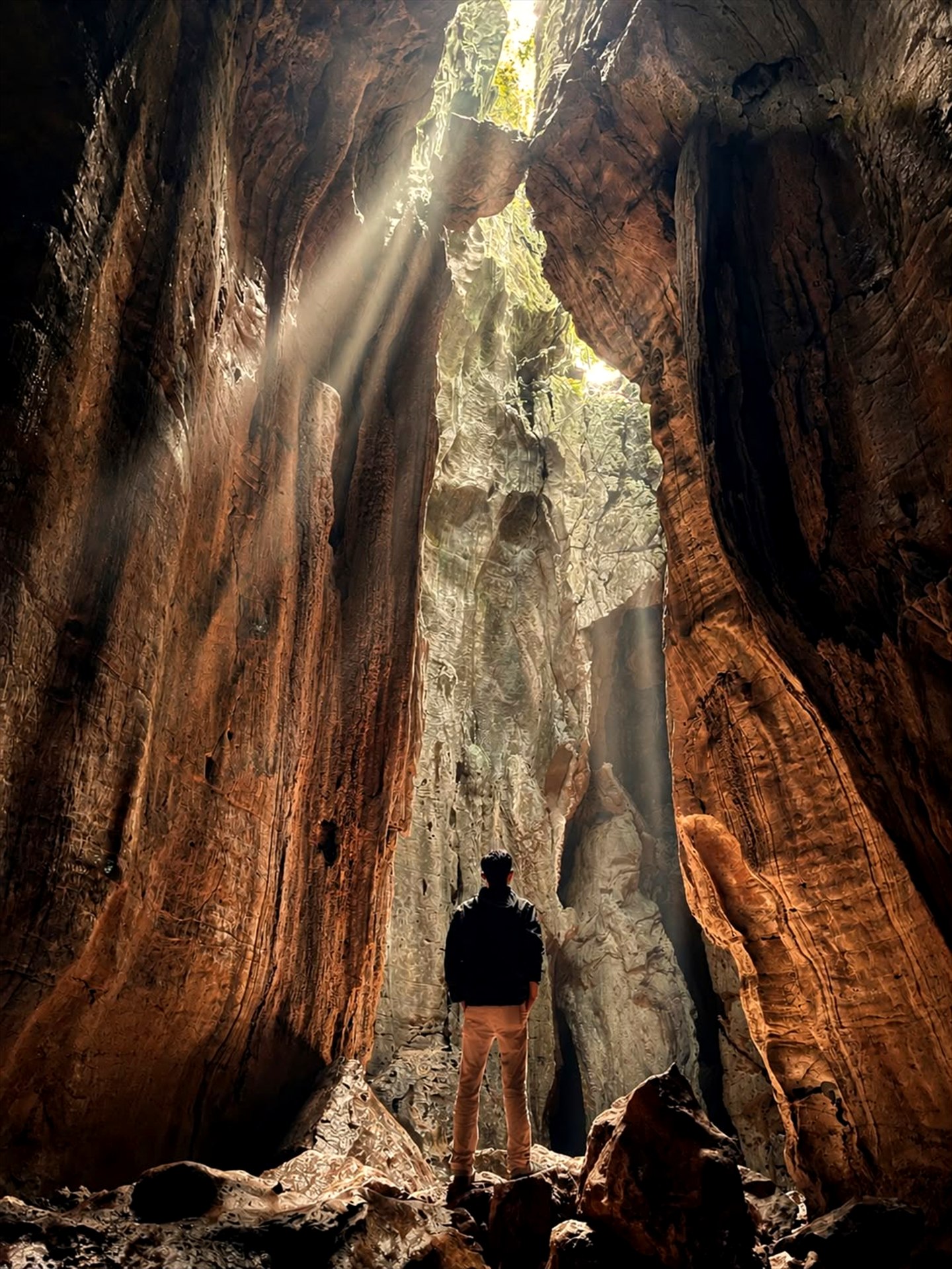 Peserta berdiri di mulut Bat Cave saat cahaya masuk ke dalam goa